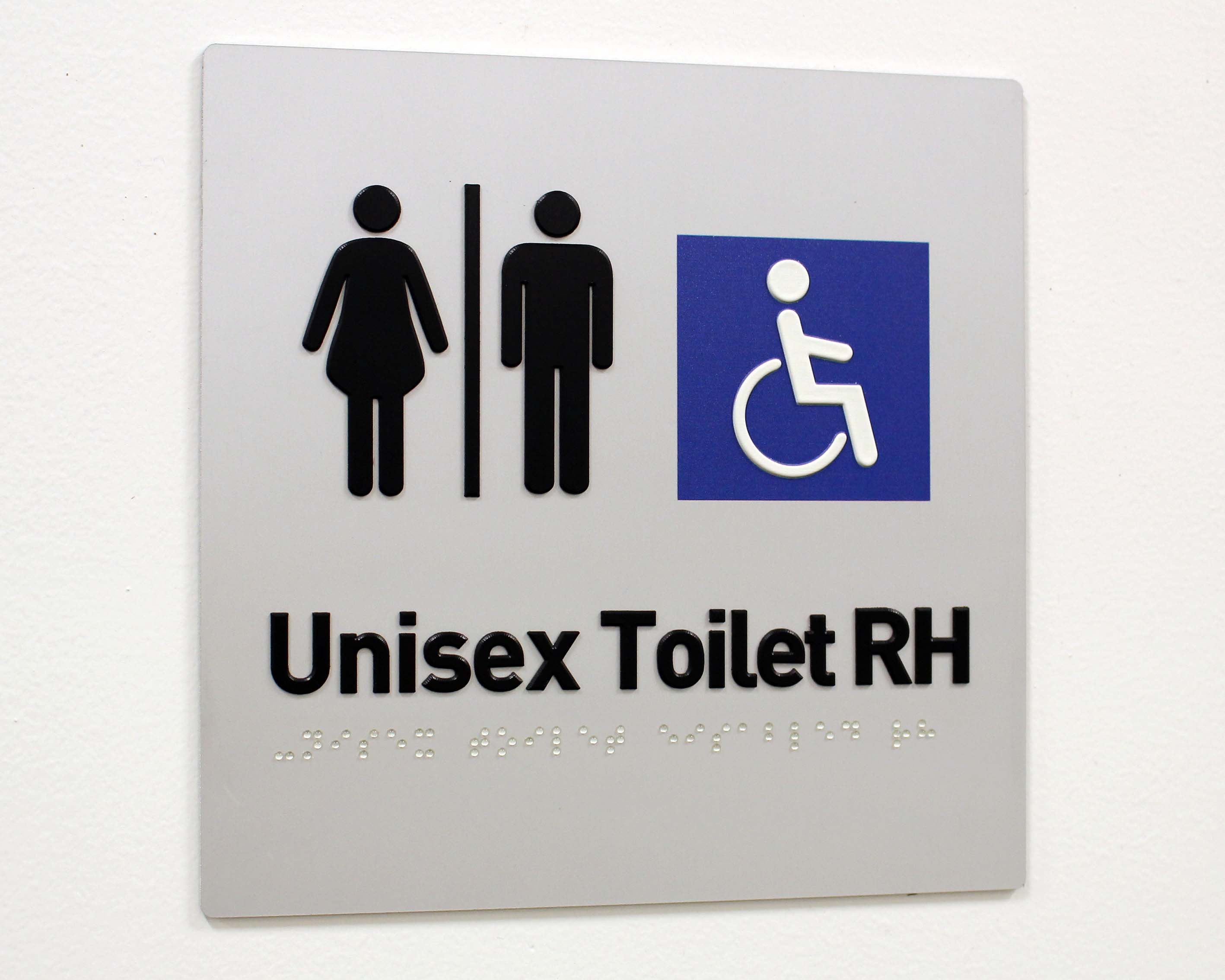 A statutory braille metal unisex toilet sign.