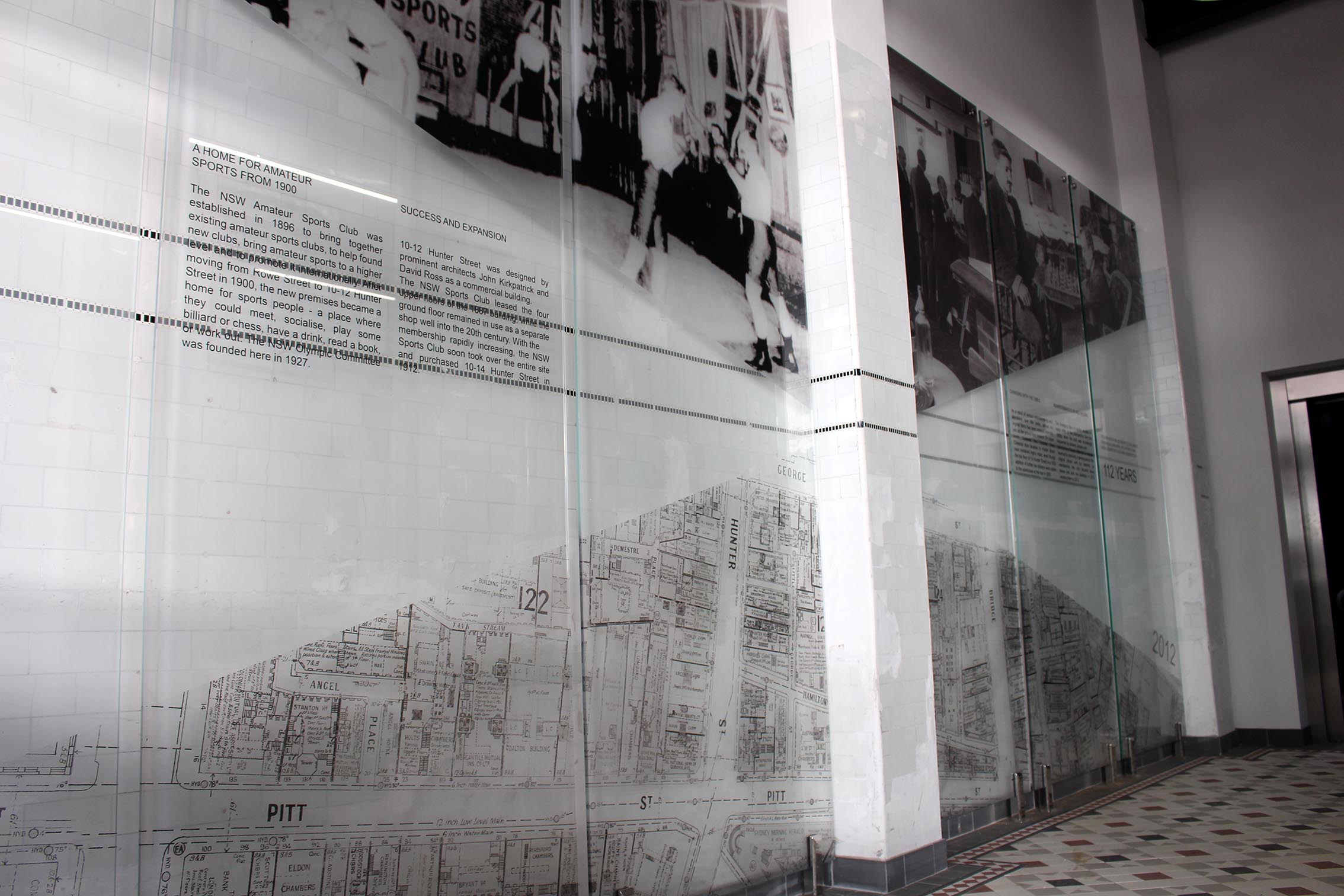 Six large pin mounted glass panels with various black and white images of the NSW Sports club in its heyday.