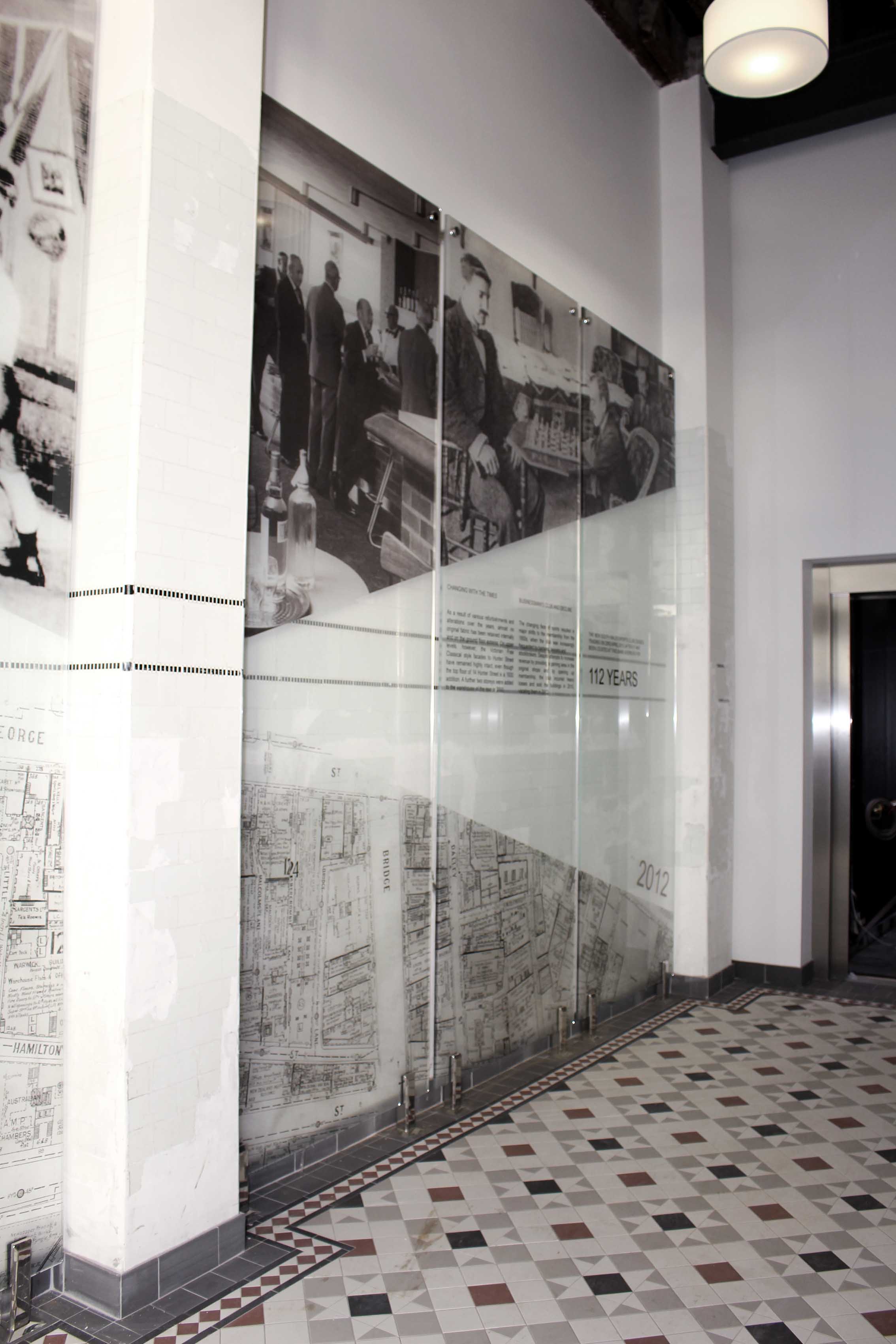 Three large pin mounted glass panels with various black and white images of the NSW Sports club in its heyday.