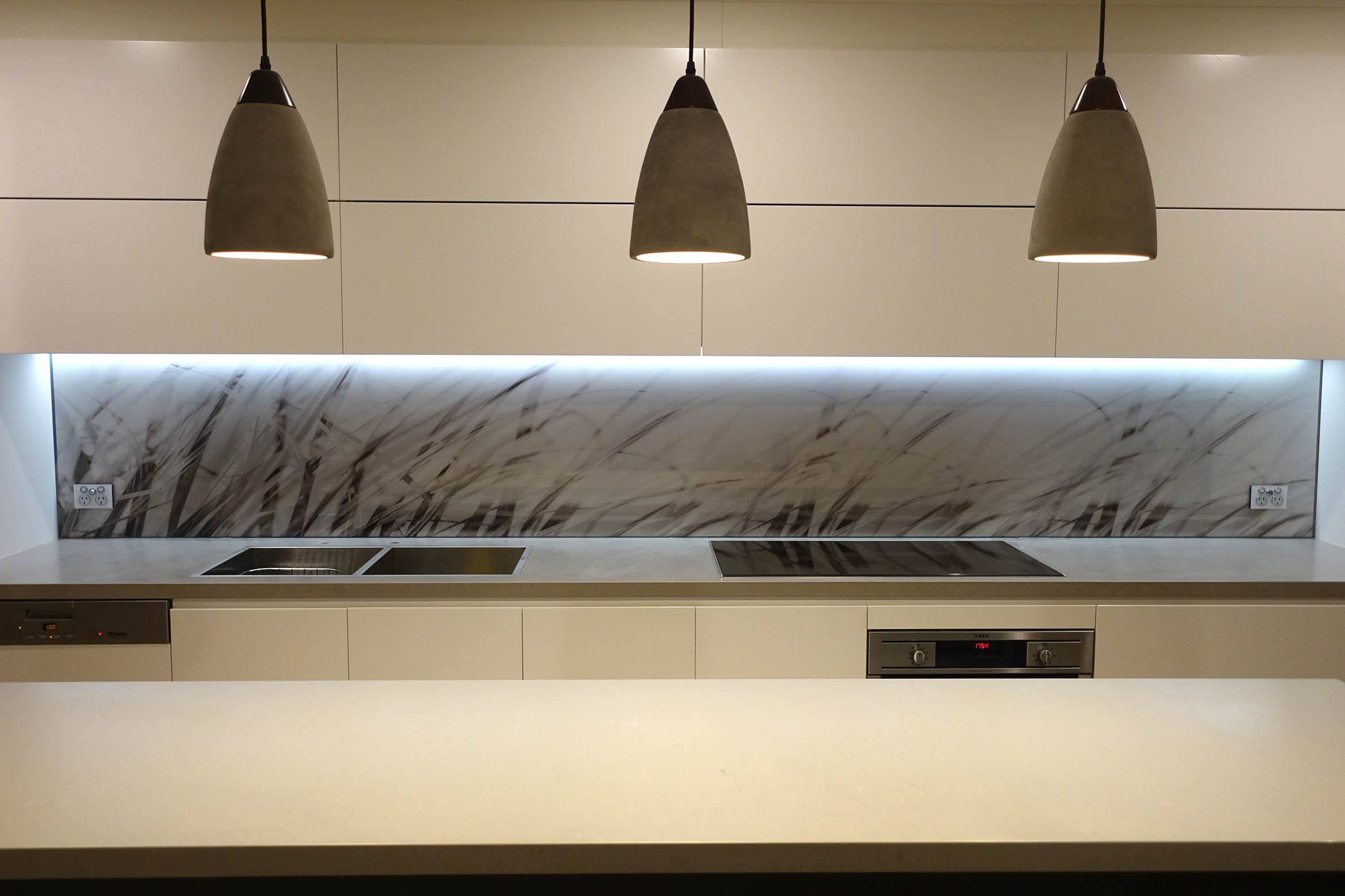 Kitchen glass splashback with black and white glass imagery.