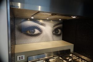 A kitchen with a custom printed splashback of a close up of a woman's eyes