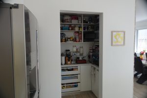 A kitchen pantry without a door