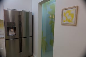 kitchen with a digitally printed translucent laminated sliding pantry door