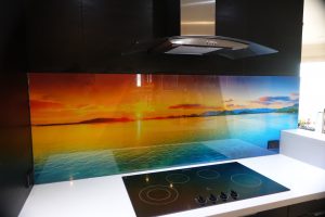 Kitchen with a custom glass printed splashback with an image of a sunset over the ocean