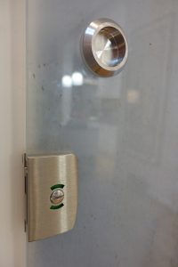 Close up picture of a lock and handle on a glass sliding door
