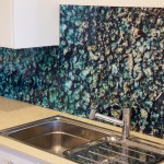 Kitchen glass splashback with ocean water and rock imagery