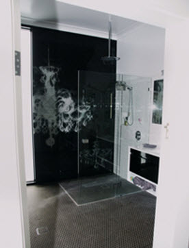 Chandelier design on bathroom glass splashback
